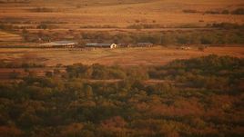 HD stock footage aerial video of approaching cattle ranch at sunrise in Oklahoma Aerial Stock Footage | HDA12_060