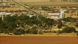 HD stock footage aerial video of a small town with a highway passing through it in Walters, Oklahoma Aerial Stock Footage | HDA12_081