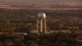 HD stock footage aerial video of flying by water tower, small businesses, Nocona, Texas, sunset Aerial Stock Footage | HDA12_150