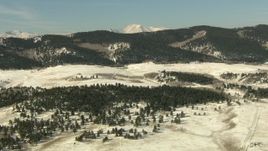 HD stock footage aerial video of flying over a snowy valley to approach Rocky Mountains, Park County, Colorado Aerial Stock Footage | HDA13_320