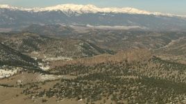 HD stock footage aerial video of hills and snow-capped Rocky Mountains, Colorado Aerial Stock Footage | HDA13_324