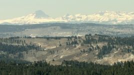 HD stock footage aerial video of the Rocky Mountains visible beyond ridges in Colorado Aerial Stock Footage | HDA13_334