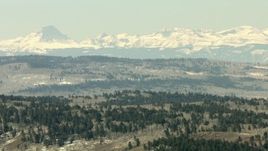 HD stock footage aerial video of a view of the Rocky Mountains beyond hills in Colorado Aerial Stock Footage | HDA13_335