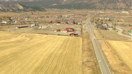 HD stock footage aerial video pan across a country highway to reveal the town of Ridgway, Colorado Aerial Stock Footage | HDA13_349_01