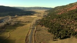 HD stock footage aerial video of following the highway past fields toward the town of Ridgway, Colorado Aerial Stock Footage | HDA13_394