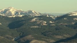 HD stock footage aerial video of Rocky Mountains with snow and evergreens at sunrise, Colorado Aerial Stock Footage | HDA13_422