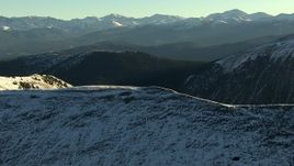HD stock footage aerial video of flying over a snowy ridge at sunrise, Rocky Mountains, Colorado Aerial Stock Footage | HDA13_440_01