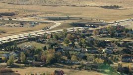 HD stock footage aerial video of a freeway interchange beside a suburban neighborhood in Castle Pines, Colorado Aerial Stock Footage | HDA13_486_02