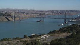 5K aerial stock footage of flying over hill, revealing Carquinez Bridge, Carquinez Strait, Vallejo, California Aerial Stock Footage | JDC01_027