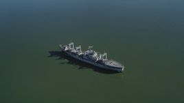 5K aerial stock footage of flying by a National Defense Reserve Fleet warship, Suisun Bay, California Aerial Stock Footage | JDC01_040