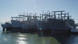 5K aerial stock footage of flying by National Defense Reserve Fleet warships, Suisun Bay, California Aerial Stock Footage | JDC01_044