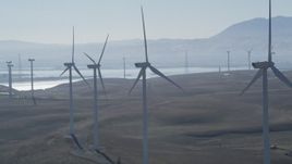 5K aerial stock footage of flying by a row of windmills, Shiloh Wind Power Plant, Montezuma Hills, California Aerial Stock Footage | JDC01_075