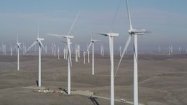 5K aerial stock footage of flying by a row of windmills, Shiloh Wind Power Plant, Montezuma Hills, California Aerial Stock Footage | JDC01_076
