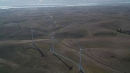 5K aerial stock footage of flying by a row of windmills, Shiloh Wind Power Plant, Montezuma Hills, California Aerial Stock Footage | JDC01_077
