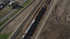 5K aerial stock footage of tracking a train moving past residential neighborhoods, fields, Pittsburg, California Aerial Stock Footage | JDC01_086