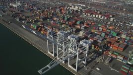 5K aerial stock footage of flying by shipping containers, cargo cranes at Port of Oakland, California Aerial Stock Footage | JDC02_011