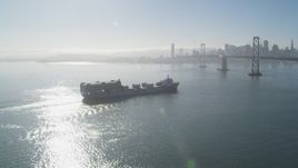 5K aerial stock footage of flying by a cargo ship approaching Bay Bridge, San Francisco, California Aerial Stock Footage | JDC02_042