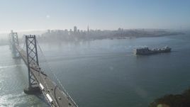 5K aerial stock footage of cargo ship, Bay Bridge, reveal Downtown San Francisco skyline, California Aerial Stock Footage | JDC02_044