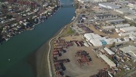 5K aerial stock footage of flying away from warehouse buildings by the Oakland Estuary and over San Leandro Bay, Oakland, California Aerial Stock Footage | JDC02_051