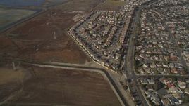 5K aerial stock footage of flying away from tract homes and marshland, Union City, California Aerial Stock Footage | JDC03_003
