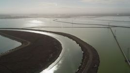 5K aerial stock footage of flying over marshland, pan across sloughs and power lines, Sunnyvale, California Aerial Stock Footage | JDC03_010