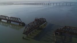 5K aerial stock footage of passing by a railroad bridge near Dumbarton Bridge, San Francisco Bay, California Aerial Stock Footage | JDC04_035