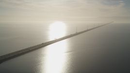 5K aerial stock footage of flying by San Mateo Bridge, sun reflecting off San Francisco Bay, California Aerial Stock Footage | JDC04_040
