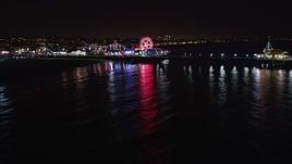 5K aerial stock footage tilt from the ocean to reveal Santa Monica Pier, California at night Aerial Stock Footage | LD01_0039