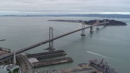 5.7K stock footage aerial video stationary view of the Bay Bridge, pan across the bay, San Francisco, California Aerial Stock Footage | PP0002_000032