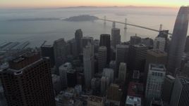 5.7K stock footage aerial video pan from Transamerica Pyramid to reveal Salesforce Tower at sunrise in Downtown San Francisco, California Aerial Stock Footage | PP0002_000060
