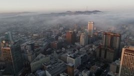 5.7K stock footage aerial video of fog rolling over Civic Center near office buildings at sunrise in San Francisco, California Aerial Stock Footage | PP0002_000075