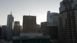 5.7K stock footage aerial video descend by skyscrapers at sunrise, reveal office building, Downtown San Francisco, California Aerial Stock Footage | PP0002_000082