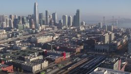 5.7K stock footage aerial video tilt from city skyline to reveal train station and condo complexes, Downtown San Francisco, California Aerial Stock Footage | PP0002_000106
