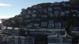 5.7K stock footage aerial video ascend by waterfront condos to a view hillside homes in Sausalito, California Aerial Stock Footage | PP0002_000131