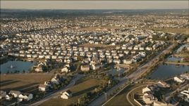 HD aerial stock footage of flying by suburban tract homes at sunset in Joliet, Illinois Aerial Stock Footage | PP001_003