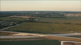 HD aerial stock footage of flying over freeway and farm fields at sunset in Homer Glen, Illinois Aerial Stock Footage | PP001_006