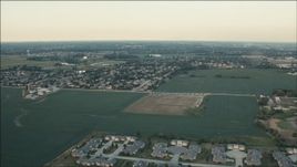 HD aerial stock footage of flying over fields to approach homes at sunset in Homer Glen, Illinois Aerial Stock Footage | PP001_008