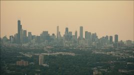 HD aerial stock footage of the hazy skyline at sunset in Downtown Chicago, Illinois Aerial Stock Footage | PP001_016