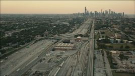 HD aerial stock footage fly over train yard by freeway to approach Downtown Chicago, Illinois at sunset Aerial Stock Footage | PP001_021