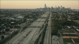 HD aerial stock footage of following freeway and train tracks at sunset to approach Downtown Chicago, Illinois Aerial Stock Footage | PP001_022