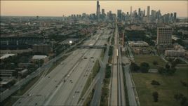 HD aerial stock footage of a commuter train heading toward Downtown Chicago at sunset, Illinois Aerial Stock Footage | PP001_023
