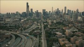 HD aerial stock footage of tilting from train tracks to reveal the skyline at sunset, Downtown Chicago, Illinois Aerial Stock Footage | PP001_024