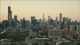 HD aerial stock footage tilt from freeway interchange to reveal the skyline at sunset, Downtown Chicago, Illinois Aerial Stock Footage | PP001_025