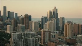 HD aerial stock footage of flying by city skyscrapers at sunset in Downtown Chicago, Illinois Aerial Stock Footage | PP001_026