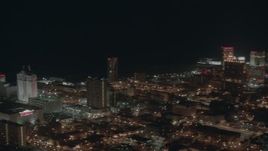 HD stock footage aerial video pan across hotels and casinos on the shore at night in Atlantic City, New Jersey Aerial Stock Footage | PP003_028