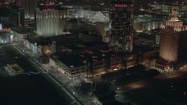 HD stock footage aerial video of tilting from hotels and casinos to the park and boardwalk at night in Atlantic City, New Jersey Aerial Stock Footage | PP003_031
