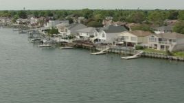 HD stock footage aerial video flyby waterfront homes with docks by the bay in Merrick, New York Aerial Stock Footage | PP003_046