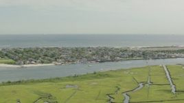 HD stock footage aerial video of a coastal community across a channel and marshes, Point Lookout, New York Aerial Stock Footage | PP003_049
