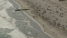 HD stock footage aerial video of approaching sunbathers on the beach, Long Beach, New York Aerial Stock Footage | PP003_053