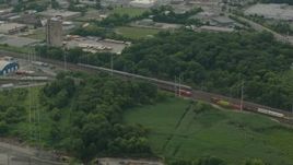 HD stock footage aerial video of a passenger train passing industrial buildings in Wilmington, Delaware Aerial Stock Footage | PP003_110
